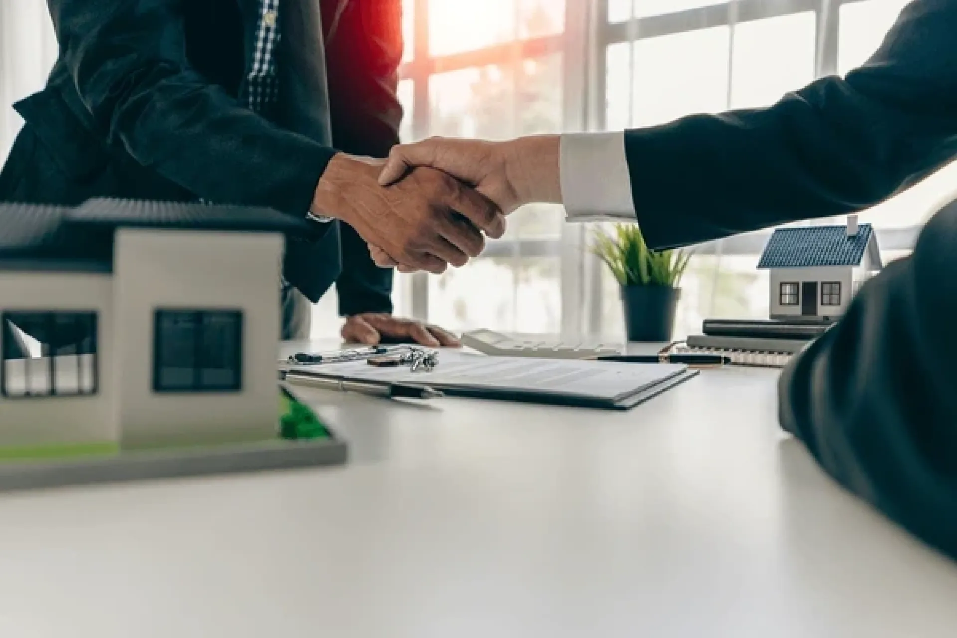 A mortgage broker meeting clients in an office, discussing agreements and loans.